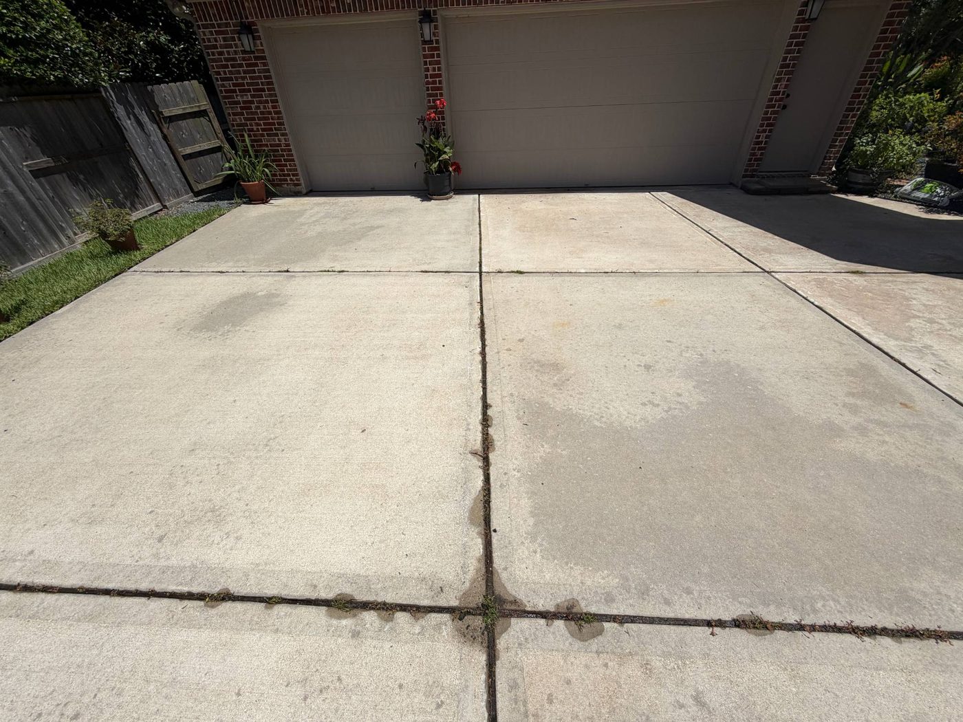 Clean two-car driveway in front of brick home